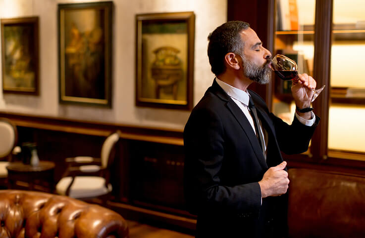 en stilig man som dricker vin